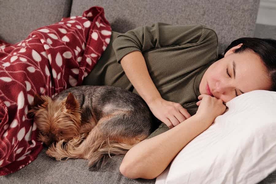 Pet therapy: woman lying on a sofa with her dog.