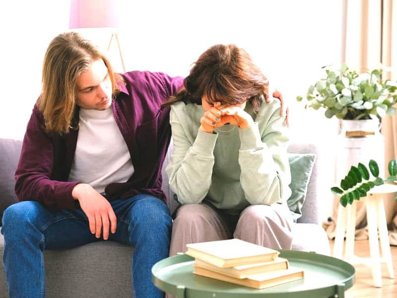 Couple comforting each other.