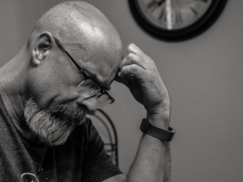 Sad bald man, illustrating men's mental health issues.